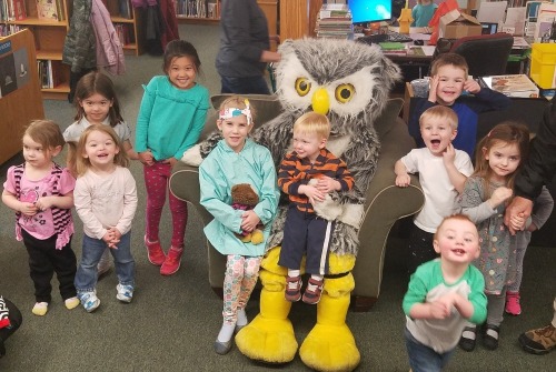 Picture of Hoot with kids sitting on his lap and gathered around him.
